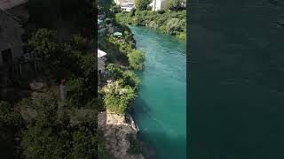 Mostar Bridge arching over emerald Neretva River MostarBridge NeretvaRiver Bosnia BalkansBeauty [upl. by Ellekcim]